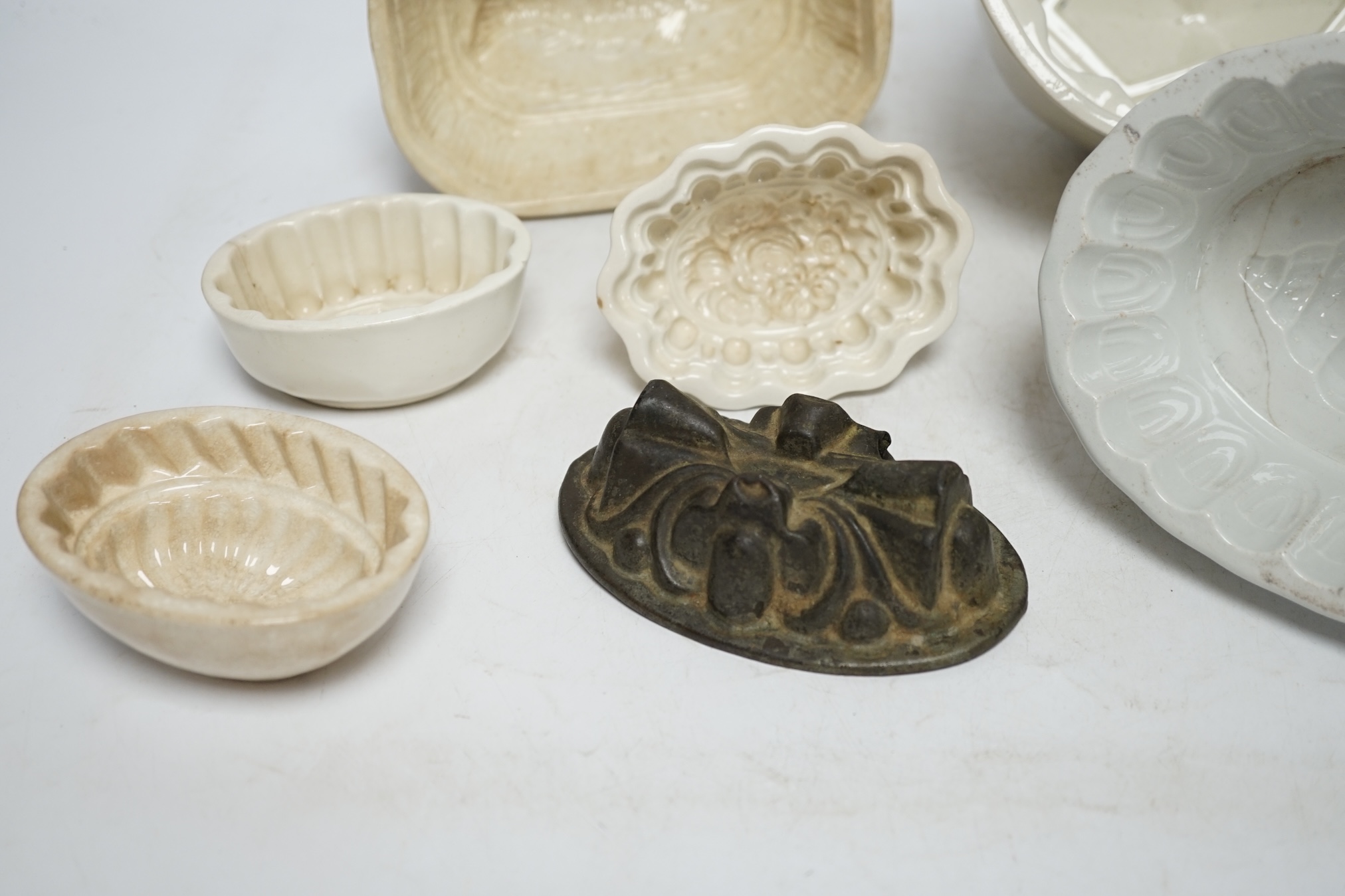 From the Studio of Fred Cuming. Seven jelly moulds including six ceramic examples, one Cetemware, largest 17cm wide. Condition - fair, one cracked